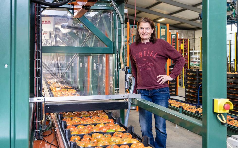 Woman standing next to SortiPack machine